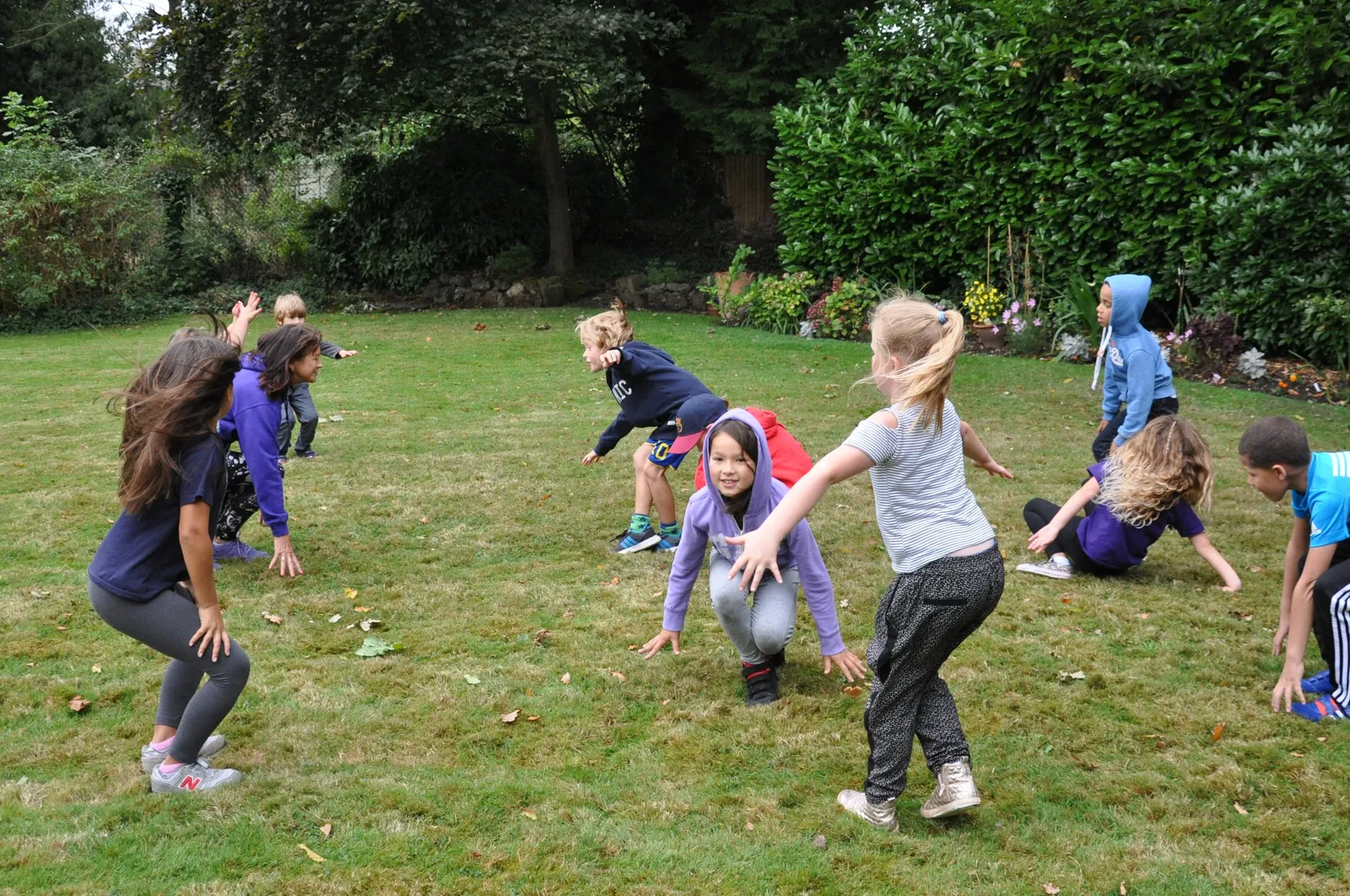 kids having fun outdoors doing exercises with kid fit parties